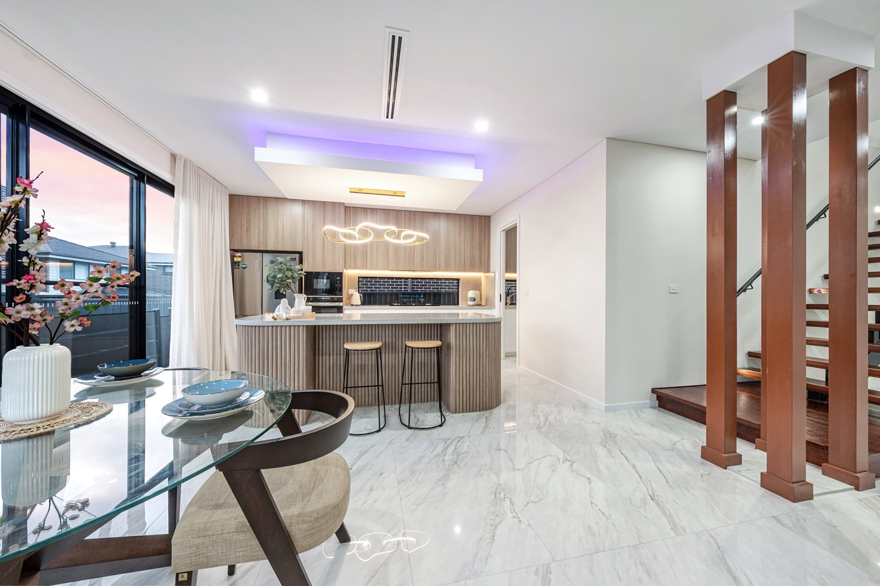 Sydney TCE kitchen and dining area with island bench and warm feature columns